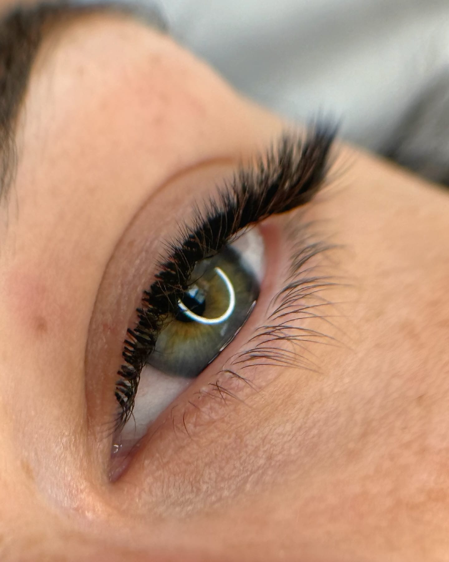 Full black volume lash extensions with a dramatic D-curl and subtle outer-corner length